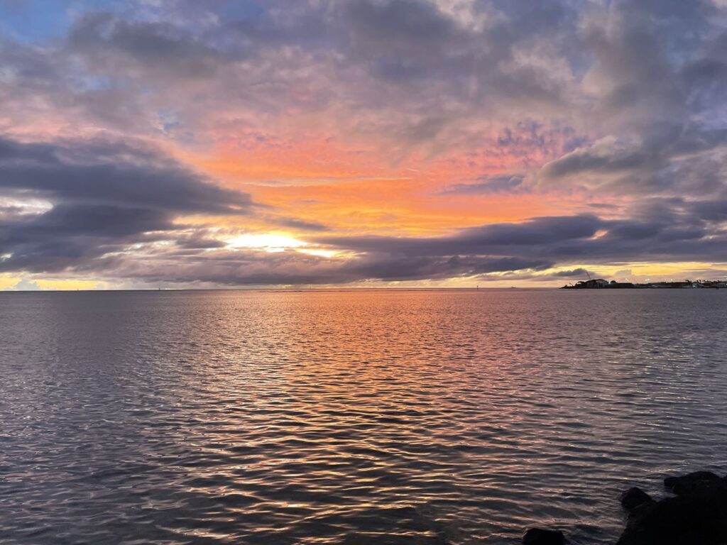 An ocean sunset in hues of orange and blue.